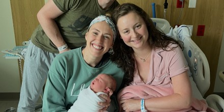 Nurse with parents and newborn in hospital