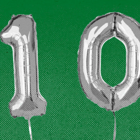 Balloons that spell the number 100, against a green background.
